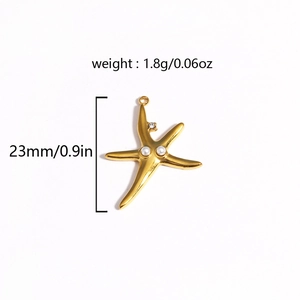 Detailed view of a gold starfish pendant with white pearls and 23mm size specifications