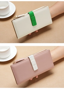 Detailed close-up of textured leather wallets in beige and pink with stylish contrast straps