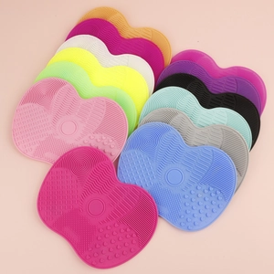 Close-up of heart-shaped silicone makeup brush cleaning mats in multiple vibrant colors