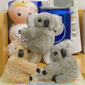 Close-up of cute plush koala hair clips in grey and brown for trendy hair decoration
