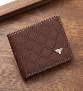 Detailed view of deep brown leather wallet with geometric diamond quilted pattern texture