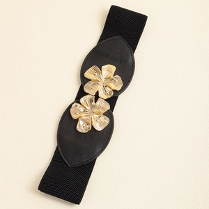 Detail of black elastic belt featuring golden metal flower buckles and faux leather accents