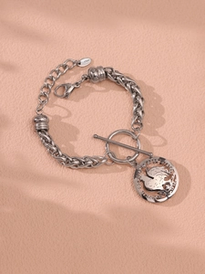 Detailed macro of stainless steel chain bracelet with round pendant and T-bar closure