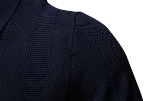 Macro shot of navy blue knit fabric showing fine striped texture and shoulder seam detail