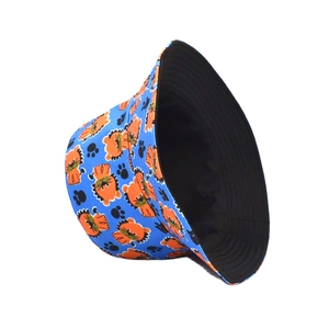 Detail of reversible bucket hat showing orange lion prints on blue fabric and black interior