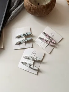 Detail of Scottie dog hair clips in pastel colors with egg lettering on cards