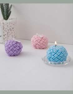 Three creative geometric woven ball scented candles in purple, pink, and blue colors