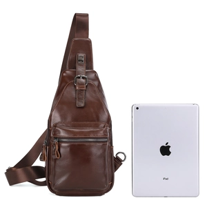 Detail of dark brown leather chest bag next to an iPad showing large storage capacity