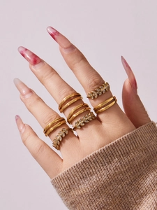 Close-up of gold leaf wheat ear rings set with zircon stones on model hand