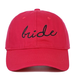 Close-up of red cotton baseball cap featuring black bride script embroidery details