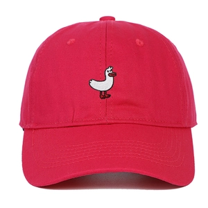 Close-up of white swan embroidery on a red cotton twill baseball cap with stitching detail