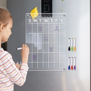 Girl writing on a clear magnetic acrylic calendar board set with six colored markers