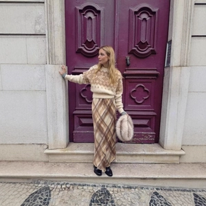 Women's autumn beige geometric knit sweater paired with a plaid long skirt in retro style