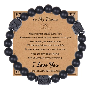 Detail of matte black beads and lava rock bracelet with kraft paper gift greeting card
