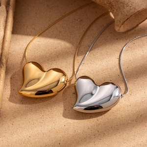 Polished heart pendant necklace in gold and silver finish with delicate metal chains