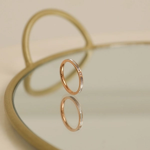 Minimalist 18k rose gold titanium ring with white shell inlay and a small central diamond
