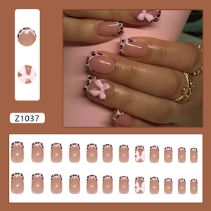 Pink French leopard print press-on nails with 3D bows in a 24-piece medium square set