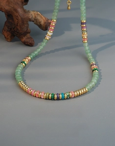 Detail of colorful beads and gold spacers on a handmade gemstone necklace in close-up