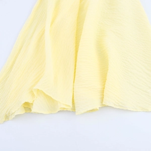Pale yellow textured crinkle fabric dress with irregular hem and large swing design
