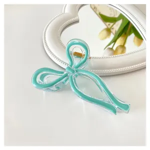 Detail view of a mint green jelly bow hair claw clip with 11cm size measurement
