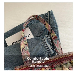 Detail of colorful woven bohemian tote bag handles with tassels on casual background