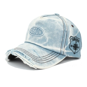 Close-up of Boston embroidery and distressed brim on light blue washed denim baseball cap