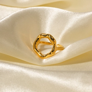 18K gold plated lava-style hollow flower ring on elegant beige silk fabric texture