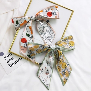 Two-pack silk-feel hair scarves featuring abstract face art and palm leaf patterns
