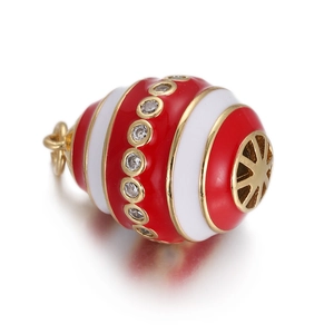 Close-up of red and white enamel evil eye pendant with gold plating and clear zircons