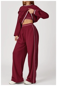 Close-up of wine red sweatshirt set with white striped piping and knit texture details