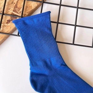Detailed close-up of blue cotton crew socks featuring elastic ribbed cuffs and knit texture