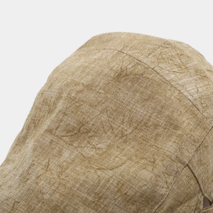 Macro detail of khaki cotton linen fabric texture and stitching on the flat cap