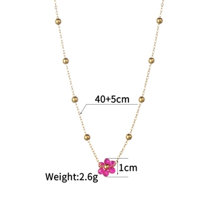 Detail view of gold beaded chain necklace with pink flower pendant and size specifications