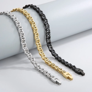 Macro shot of double-layered titanium steel chains in silver, gold, and black finishes
