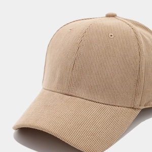 Close-up of fine corduroy texture on a khaki baseball cap with detailed stitching