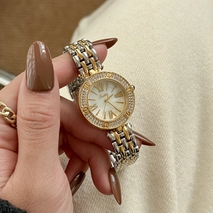 Two-tone gold and silver ladies watch with diamond bezel and roman numeral white dial