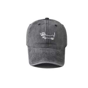 Detail of dachshund embroidery on vintage washed cotton baseball cap with ventilation eyelets