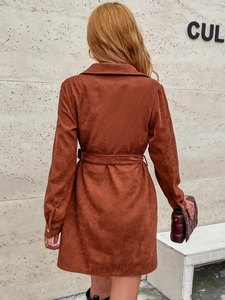 Back view of caramel corduroy shirt dress featuring a waist belt and metal cuff buttons