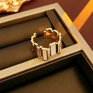 Detail of adjustable gold-plated ring with rectangular shell inserts and cubic zirconia