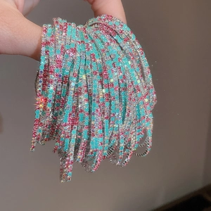 Macro shot of thin colorful crystal stretch bracelets with pink and blue stones