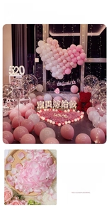 Detailed view of artificial rose petals and glowing heart-shaped proposal decorations