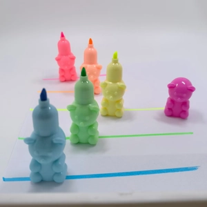 Five stackable bear-shaped highlighters with colorful ink strokes on white background