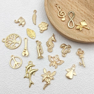 Macro view of assorted KC gold alloy charms including music notes and animal shapes