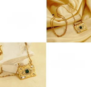 Detailed shot of evil eye necklace with malachite stone on 18K gold titanium steel