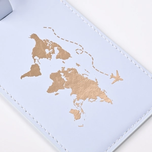 Detail of light blue PU leather luggage tag with gold stamped world map and airplane