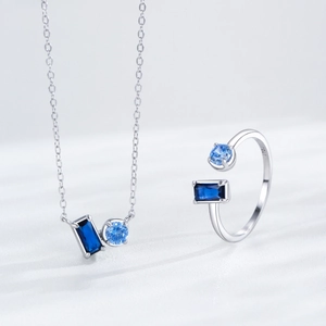 Elegant S925 silver jewelry set with blue sapphire ring and necklace on white background