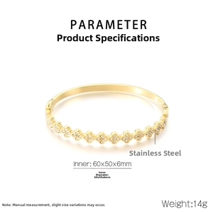 Macro shot of gold stainless steel bangle featuring zircon-encrusted clover patterns and specs