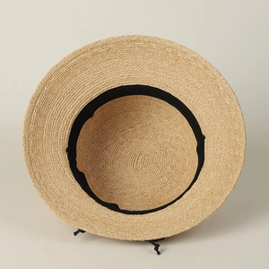 Detail of raffia sun hat featuring an internal sweatband and adjustable drawstring