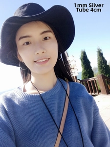 Model wearing 40mm silver oversized hoop earrings with 1mm thin tube diameter