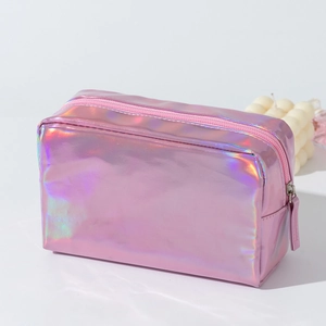 Macro view showing the metallic laser holographic PU surface and zipper of the pink makeup bag